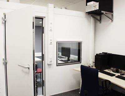 Photo of EEG laboratory with EEG chamber and desk.